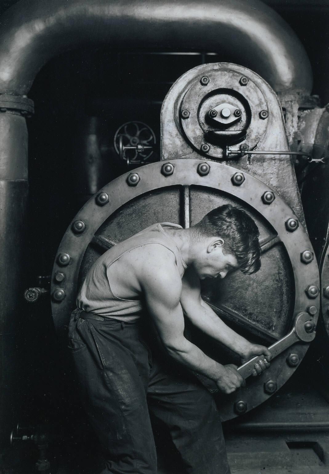 Lewis Hine, Power House mechanic working on steam pump, 1920