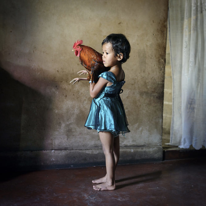 Yasmin holds a rooster